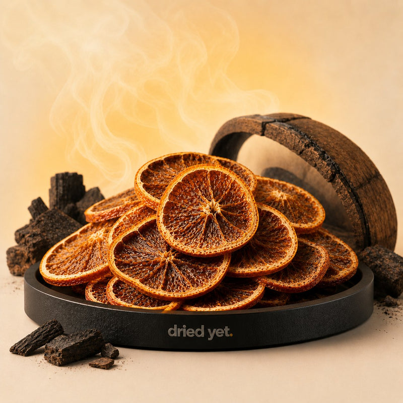 Dried Yet. smoked orange cocktail garnish beside charred oak