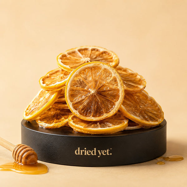Dried Yet. honey lemon slices with a honey dipper on a branded display stand