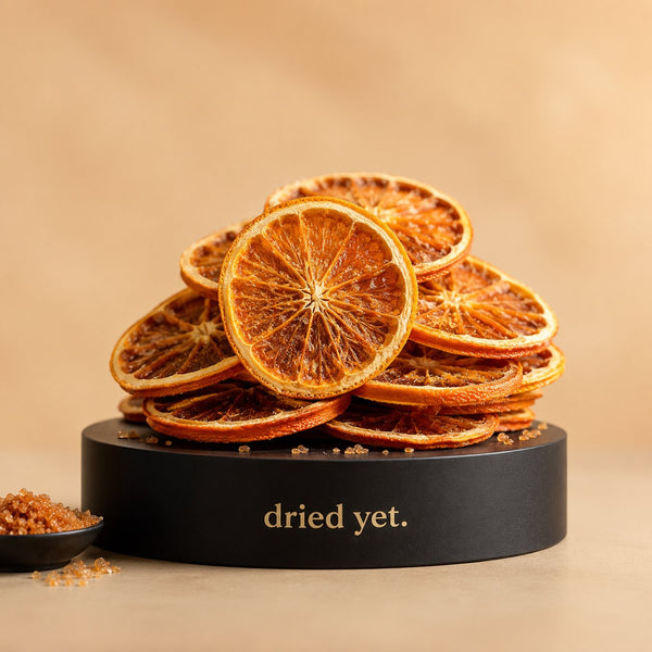 Dried Yet. orange brown sugar slices on a branded display stand